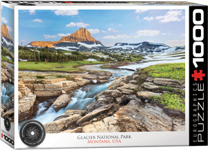 The image features a mountain range with a prominent peak at the center, colored in earthy tones of orange and brown, and dusted with snow. In the foreground, a rapid stream cascades over layered, light-colored rocks, flowing through a lush green meadow dotted with snow patches. Pine trees populate the mid-ground, adding a deep green contrast. The sky above is a brilliant blue, scattered with fluffy white clouds. The title, "Glacier National Park, Montana, USA" is printed in white on red background along the left hand edge. On the bottom edge, the company logo reads "EUROGRAPHICS PUZZLES" and the number ‘1000’ after it indicates the puzzle piece count. In the bottom left, there is a picture of a camera lens with the words "HDR Photography - Scenic Landscape" printed on the inside rim of the lens. The image features a mountain range with a prominent peak at the center, colored in earthy tones of orange and brown, and dusted with snow. In the foreground, a rapid stream cascades over layered, light-colored rocks, flowing through a lush green meadow dotted with snow patches. Pine trees populate the mid-ground, adding a deep green contrast. The sky above is a brilliant blue, scattered with fluffy white clouds. The title, "Glacier National Park, Montana, USA" is printed in white on red background along the left hand edge. On the bottom edge, the company logo reads "EUROGRAPHICS PUZZLES" and the number ‘1000’ after it indicates the puzzle piece count. In the bottom left, there is a picture of a camera lens with the words "HDR Photography - Scenic Landscape" printed on the inside rim of the lens.