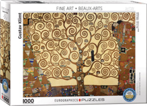 The image shows a puzzle box featuring the piece “Tree of Life” by Gustav Klimt. The image depicts a tree with intricate swirling branches on a golden background. To the left, there is a figure with distinct geometric patterns in the clothing, composed of triangles and rectangles in earthy browns and blues. On the right, another figure is depicted, richly adorned with repeating circular patterns and vibrant colors. Along the top is printed the collection name, “Fine Arts.” The bottom left has the number '1000' indicating the number of pieces in the puzzle. Along the bottom edge, the company logo reads "EUROGRAPHICS PUZZLES." A blue badge in the lower right corner indicates the puzzle is an officially licensed reproduction of museum quality. The image shows a puzzle box featuring the piece “Tree of Life” by Gustav Klimt. The image depicts a tree with intricate swirling branches on a golden background. To the left, there is a figure with distinct geometric patterns in the clothing, composed of triangles and rectangles in earthy browns and blues. On the right, another figure is depicted, richly adorned with repeating circular patterns and vibrant colors. Along the top is printed the collection name, “Fine Arts.” The bottom left has the number '1000' indicating the number of pieces in the puzzle. Along the bottom edge, the company logo reads "EUROGRAPHICS PUZZLES." A blue badge in the lower right corner indicates the puzzle is an officially licensed reproduction of museum quality.