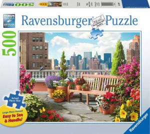 A puzzle with the words “Ravensburger Puzzle” at the top and the number ‘500’ along the left side of the white bordered cover.  Below is an image of the finished puzzle, which features a rooftop garden in a city.  The roof is scattered with terracotta pots filled with flowers, bushes, and small, carefully trimmed trees.  A bench sits beside the ledge with more puts on one side of it, with the other kept clear for sitting.
