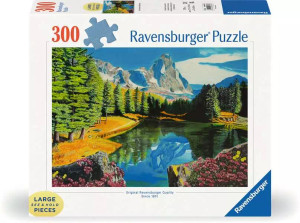 A puzzle with the words “Ravensburger Puzzle” at the top and the number ‘300’ along the left side of the white bordered cover.  Below is an image of the finished puzzle, which features a scene from the Rocky Mountains with a calm body of water in the foreground, evergreen mountains in the mid, and tall, snowcapped mountains in the distance. A puzzle with the words “Ravensburger Puzzle” at the top and the number ‘300’ along the left side of the white bordered cover.  Below is an image of the finished puzzle, which features a scene from the Rocky Mountains with a calm body of water in the foreground, evergreen mountains in the mid, and tall, snowcapped mountains in the distance.