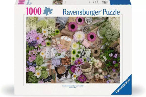 A puzzle with the words "Ravensburger Puzzle" and the number '1000' at the top of the white bordered cover.  In the middle is an image of a table covered with flower tops and bushels in various shades of creme, green, and light purple.  Interspersed between these flowers are twine, scissors, paper tags, and similar elements often included in the binding and display of bouquets.