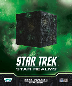 Board game expansion titled "Star Trek: Star Realms: Borg: Invasion" featuring art of a green nebula in the background, with a large, black cube floating in the air in the foreground. Board game expansion titled "Star Trek: Star Realms: Borg: Invasion" featuring art of a green nebula in the background, with a large, black cube floating in the air in the foreground.