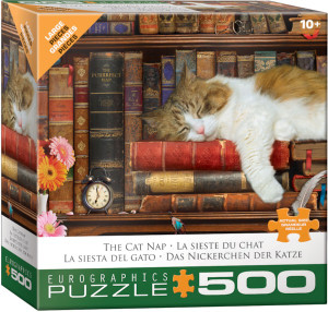 A puzzle titled, “The Cat Nap,” at the bottom in several different languages, with the artist's name right above it.  The company logo “Eurographics Puzzle” is in large font along the bottom, and number ‘500’ right next to it in the cover’s dark green border.  In the center is what the completed puzzle looks like: a brown and white furred cat sleeping on an overfilled bookshelf.