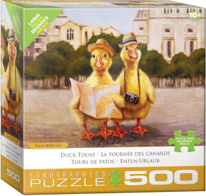 A puzzle titled, “Duck Tours” at the bottom in several different languages, with the artist's name right above it.  The company logo “Eurographics Puzzle” is in large font along the bottom, and number ‘500’ right next to it in the cover’s mustard yellow border.  In the center is what the completed puzzle looks like: a scene from a brick-paved city with two yellow ducklings in the center, both with straw hats, one with binoculars, and one holding a paper map in their little wings.