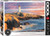 A Eurographics Puzzle of a photograph of a picture of Peggy's Lighthouse in Nova Scotia (say that ten times fast).  Water worn stone just into the the salty tides as a white lighthouse with a red light at the top breaks the skyline.  Clouds painted orange and blue stripe the sky behind.