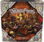 A board game titled "The Yawning Portal" in a white font where the first and last letters extend underneath to form a swirly underline.  The art of the box is a scene of a rowdy, medieval-style inn with fantasy beings of all shapes, sizes, genders and colors.  In the center of the foreground is a table with a large, plated hunk of meat.  People lift flaggons, and a barkeep in the back carries more drinks to a customer.  Behind them is a fireplace designed to look like a large face with the fire blazing in the long, open mouth. A board game titled "The Yawning Portal" in a white font where the first and last letters extend underneath to form a swirly underline.  The art of the box is a scene of a rowdy, medieval-style inn with fantasy beings of all shapes, sizes, genders and colors.  In the center of the foreground is a table with a large, plated hunk of meat.  People lift flaggons, and a barkeep in the back carries more drinks to a customer.  Behind them is a fireplace designed to look like a large face with the fire blazing in the long, open mouth.