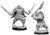 Two unpainted Orc miniatures on a white background. The one on the left is wielding swords and the one on the right is wielding an axe.