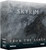 A board game titled "The Elder Scrolls: Skyrim - Adventure Board Game From the Ashes Expansion" in white text at the top and bottom of the grey box.  The art depicts a black dragon's corpse laid in dingy snow, rays of sunlight barely streaking across the image.