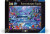 A puzzle with the words “Ravensburger Puzzle” at the top and the number ‘500’ along the left side of the black bordered cover.  At the bottom is a subtitle reading "Glow in the Dark".  In the center is an image of the finished puzzle, which features a moonlit scene of a shoreline filled to the brim with colorful fish and breaching dolphins.