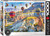 A puzzle titled, “Air Balloons over Cappadocia, Turkey,” at the bottom in several different languages.  The company logo “Eurographics Puzzle” is in large font along the right side, and number ‘1000’ right next to it in the cover’s black and white border.  In the center is what the completed puzzle looks like: an aerial view of air balloons floating above green plateaus and mountains.  The balloons feature bright colors and patterns that distinguish them from both the surrounding landscape and each other, likely for both spotting from a distance and search and rescue purposes.