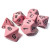 A set of 7 polyhedral dice with differing numbers of sides with an opaque, light pink resin and black numerals.
