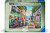 A puzzle with the words "Ravensburger Puzzle" and the number '1000' at the top of the white bordered cover.  In the middle is an image of a cobblestone street close by to a beach.  On either side are small shops with pastel paint, and in the center are four people: two parents, and two young children.  They walk down the street with bags in hand toward the beach.  Puddles are visible in the gutters and shady areas of the walk.