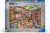A puzzle with the words "Ravensburger Puzzle" and the number '1000' at the top of the grey bordered cover.  In the middle is an image of an exorbitantly well-stocked children's toy store.  All items are brightly colored, diverse in design, and grouped based on what they are.  Shelves line the walls ceiling high of figures, books, and plushes,  Dolls stand grouped around a staircase to the second floor.  Blocks litter the center of the room atop a rainbow carpet.