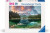 A puzzle with the words "Ravensburger Puzzle" and the number '1000' at the top of the white bordered cover.  In the middle is a photograph of an almost unnaturally still freshwater lake with green depths, a distant mountain range, and which is flanked by pine trees.