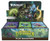 A TCG booster box titled “Magic: The gathering - Secrets of Strixhaven: Play Boosters” across the display tab and bottom.  The art depicts a green, murky realm featuring mushrooms and floating folds of blue and silver.  On the display tab are five mages of various fantastical species, each casting a swirl of magic as they look up at the viewer.
