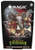 A preconstructed deck titled “Magic: The Gathering - Secrets of Strixhaven: Lorehold Spirit” Across the top and bottom of the box.  The art features a black background and a central piece depicting an anthropomorphic elephant with trimmed tusks, an aviator cap, a leather and red cloth jacket, and glowing white magic coming from their hands.  The magic surrounds a bust of an elephant and statues with glowing eyes float behind them.
