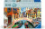 A puzzle with the words “Ravensburger Puzzle” at the top and the number ‘200’ along the left side of the cover.  Beside it is a puzzle piece with ‘XL’ inside, and the whole top of the cover has a thick, green rectangle.  Below is an image of the finished puzzle, which features a painting of the city of venice.  People meander across a bridge that crosses a canal, under which a gondola floats.  The building are doused in bright colors, and the afternoon sun brightens both the paint and the sections of exposed brick.