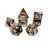 A set of 7 polyhedral dice with brown and white, opaque resin and white numerals.  On at least one side of each die is a white mimic icon: a creature that disguises itself as a treasure chest and possesses a mouth full of fangs, a long tongue, and at least two eyes on the top of the chest.