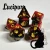 A set of black and red swirled polyhedral dice with golden numerals and cats on one side instead of numbers.  In the bottom right corner is a black cat cartoon with red highlights, drippy candles, and glowing yellow eyes.