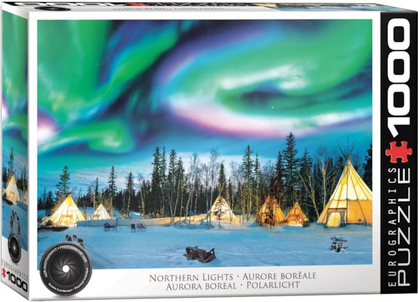 A Eurographics puzzle titled "Northern Lights" of a scene taken at night in Yellowknife, Canada. Swarling strips of radiation from our sun's rays ribbon across the night sky in green, blue, and purple.  Below is a snowy forest scape dotted with tupiq tents aglow with golden light.