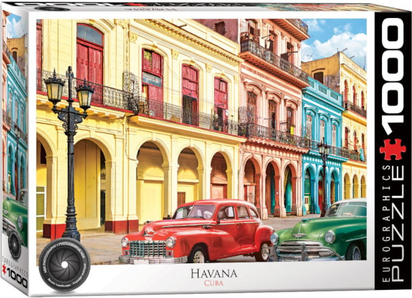 A Eurographics puzzle titled "La Havana, Cuba."  The buildings are a combination of Moorish and Baroque architecture and painted in bright, sun bleached yellows, reds, and blues.  Old models of cars with bubbly bodies line the streets and an old gas street lamp stands in the foreground.  The sky is blue and dotted in cumulus clouds above.