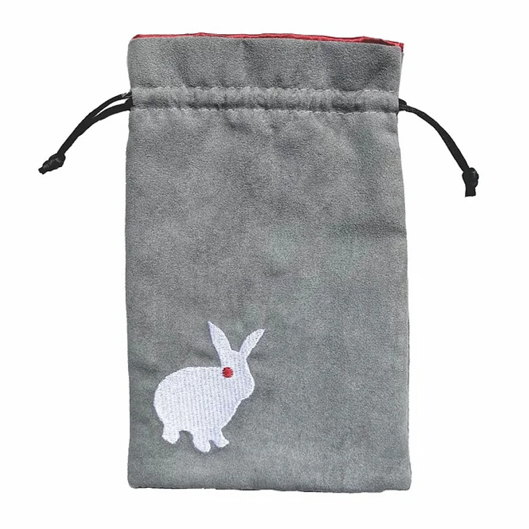 Grey dice bag with an embroidered image of a white rabbit with red eyes by Black Oak Workshop.