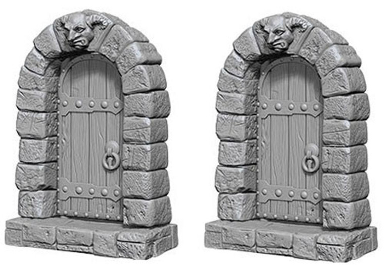 Two unpainted Door miniatures on a white background.