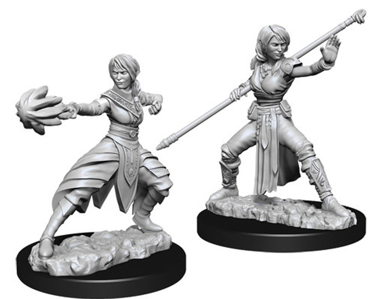 Two unpainted Female Half-Elf Monk miniatures on a white background. The one on the left is casting a spell and the one on the right is wielding a staff.