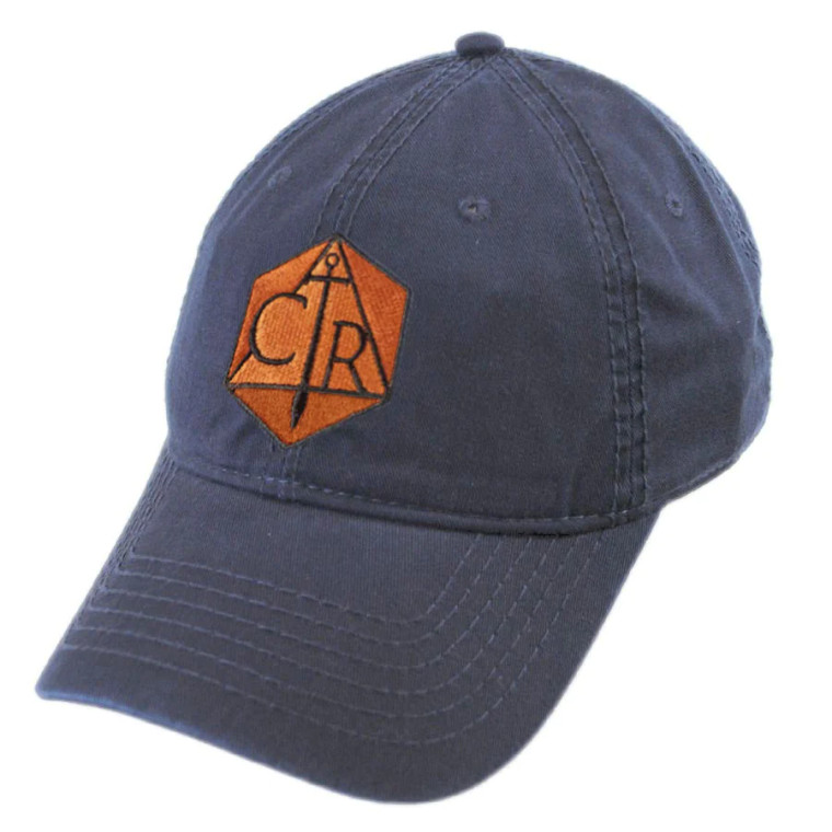 A navy blue hat with a curved visor featuring a bronze Critical Role logo patch.