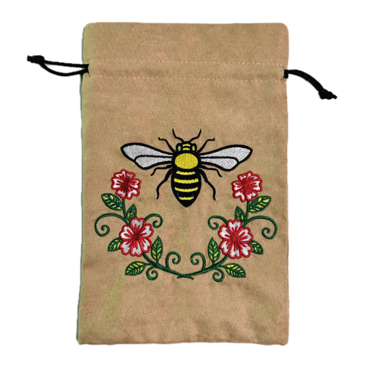 A tan dice back with draw strings and an embroidered image of a honeybee with flowers beneath it.