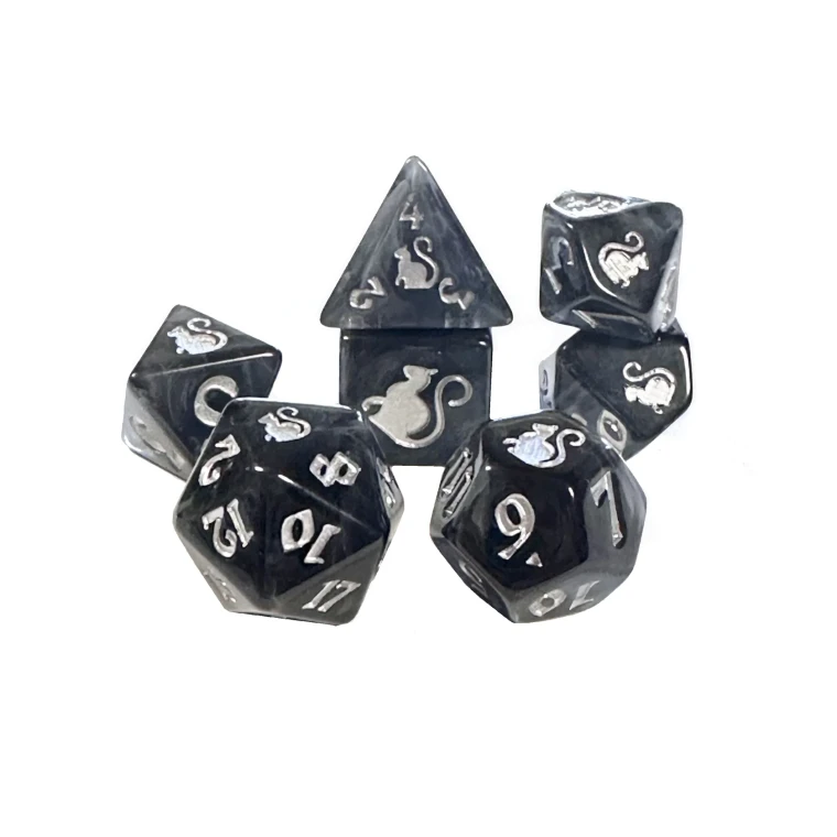 A set of 7 black and grey,  semi transparent polyhedral dice with silver numerals.  A cat icon sits on one side of each die, its tail curled beneath it.