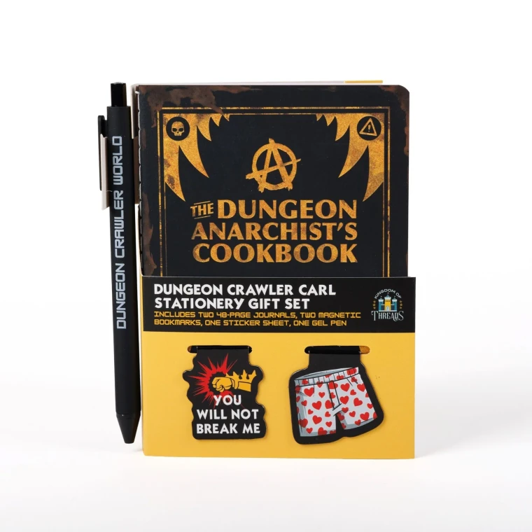 A gift set that includes a small notebook with a black cover and yellow text that reads "A Dungeon Anarchist's Cookbook," two page clips, one with a pair of boxers and one featuring a fist and text that reads, "you will not break me," and a black pen.