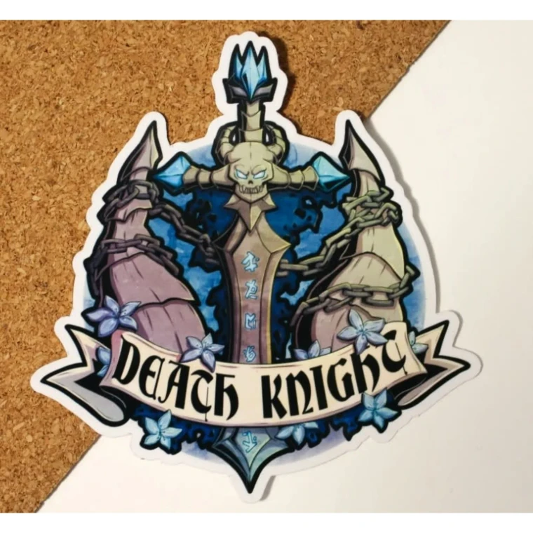 A vinyl sticker featuring a vibrant illustration of a large, dark sword with a glowing, horned skull in the hilt and similarly glowing blue runes down the façade.  Ridged horns with dark chains connecting them rise behind, and the whole scene is dotted with small blue flowers and leaves.  Below is a scroll that reads, "Death Knight," in large, black font.