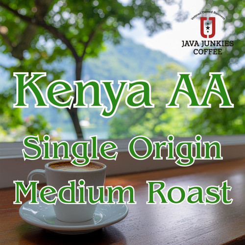 Java Junkies Kenya AA Coffee. White cup of coffee sitting on a table overlooking the mountain side and some trees.