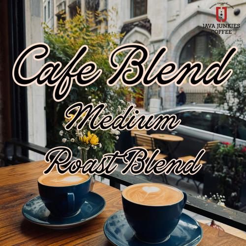 Java Junkies Cafe Coffee Blend. Two black cups of coffee filled with creamy coffee sitting next to the cafe window overlooking the French Streetside.