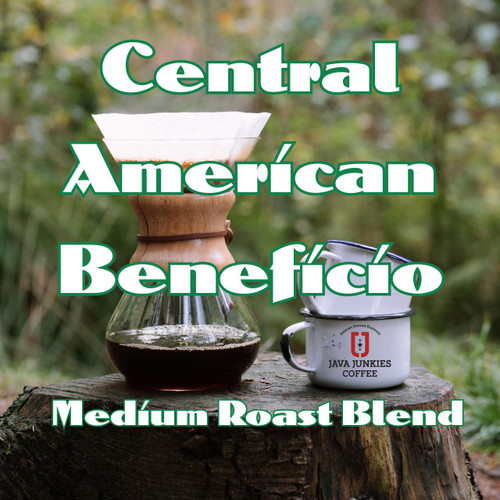 Java Junkies Organic Central American Beneficio Coffee. Pour over coffee maker and two coffee mugs sitting on a tree stump in the forest.