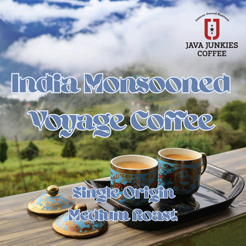 Java Junkies India 'Monsooned Voyage' Coffee. Blue coffee cups filled with creamy coffee sitting on a tray overlooking cloudy covered mountains.