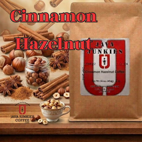 Java Junkies Cinnamon Hazelnut Coffee. Brown weaved bowl full of hazelnuts and cinnamon sticks on a light brown wood table.
