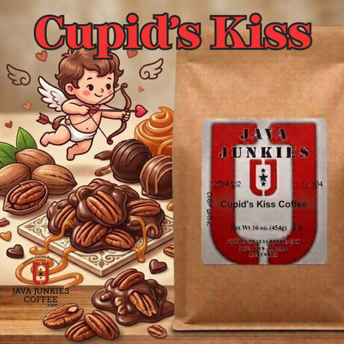 Java Junkies Cupid's Kiss Coffee. Chocolate covered caramel pecan clusters on a white table witha cute cupid.