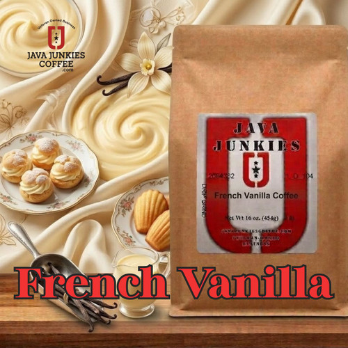 Java Junkies French Vanilla Coffee. Vanilla flowers scattered on a dark brown wooden table next to whole vanilla beans and French pastries.