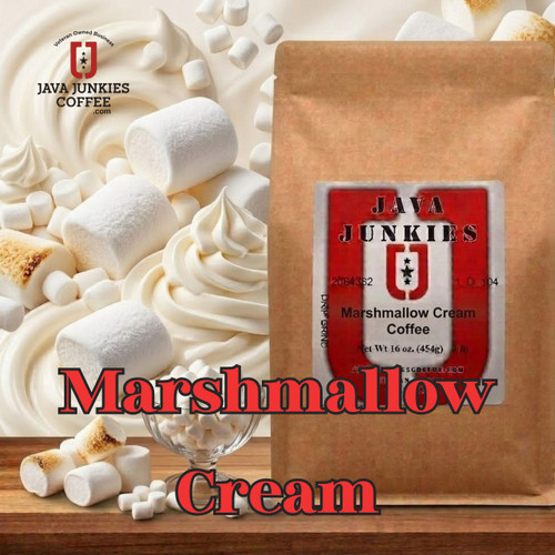 Java Junkies Marshmallow Cream Coffee. Tall mug of creamy coffee with 3 large marshmallows surrounded by other marshmallows and other large marshmallows.