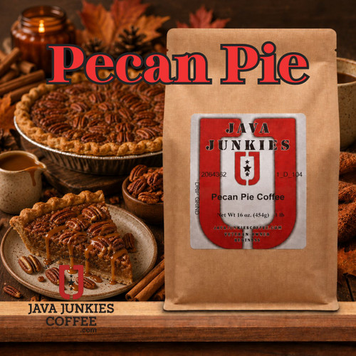 Java Junkies Pecan Pie Coffee. Pecan pie resting on the blue tablecloth next to a hot cup of coffee in a blue mug next to a pile of pecans.