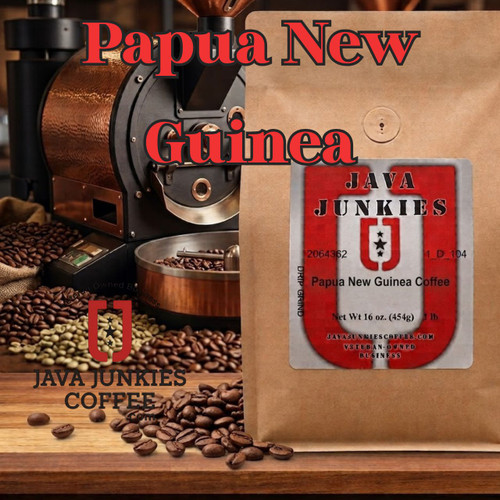 Java Junkies Papua New Guinea Coffee Bag. Pile of coffee beans from a spilled antique coffee roaster on a light brown table.