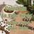 Java Junkies Columbia 'La Valle Verdi' Coffee. White cup of coffee filled with coffee beans sitting next to a burlap bag that says Cafe De Colombia.