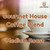 Java Junkies Gourmet House Coffee Blend. White coffee cup sitting on a white saucer with a white background .
