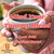 Java Junkies Mind Your Tummy Blend Coffee. White coffee cup full of coffee being held with 2 hands by a woman in a pink sweater.