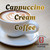 Java Junkies Cappuccino Cream Coffee.  Elegant white coffee cup sitting on saucer filled with coffee and cream coffee art on a beige table.