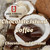 Chocolate Island Coffee. A coconut split in half laying on a dark wood table and they are filled up with chocolate chunks next to a coffee cup.