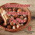 Java Junkies Cinnamon Hazelnut Coffee. Brown weaved bowl full of hazelnuts and cinnamon sticks on a light brown wood table.