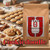Java Junkies Cookiedoodle Coffee. Large tray of snickerdoodle cookies in the background surrounded by more cookies and a big bag of coffee
